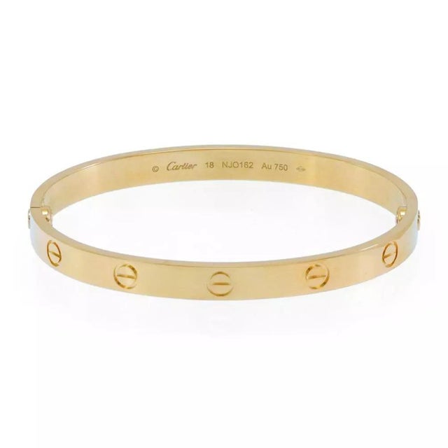 This is the iconic authentic bracelet by Cartier, from the LOVE Collection . It is well crafted from 18k yellow gold in a...