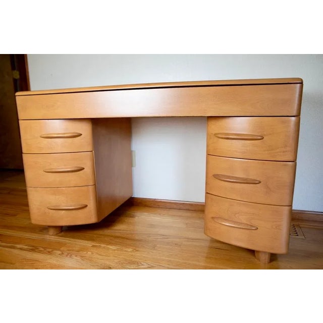 This is a classic mid-century modern desk, crafted from solid Northern Yellow Birch by the Heywood-Wakefield Company in...