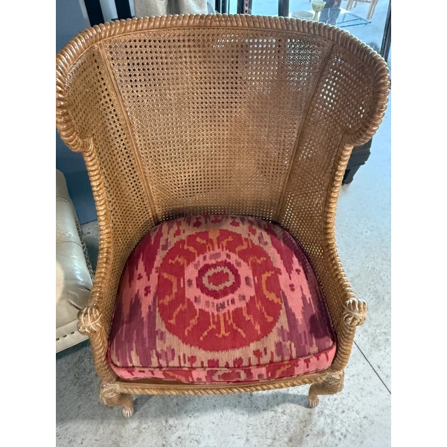 This vintage caned back wing chair has double layers of caning on the back an sides with a carved rope style border with...