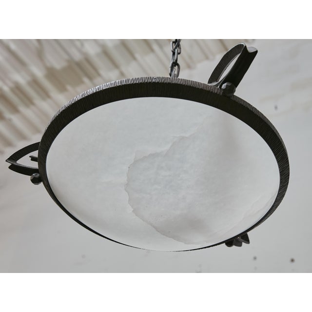 This pair of French ceiling light fixtures, dating to circa 1930, combines the natural elegance of alabaster with the...