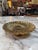 Elegant vintage solid brass pedestal bowl featuring a dramatic fluted shell-inspired design with a scalloped rim and...