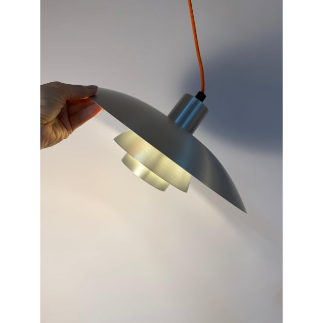 The ph 4/3 louvered lamp was designed by the visionary danish designer poul henningsen for the traditional manufacturer...