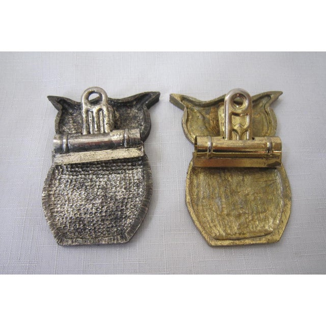 Charming pair of metal Mid Century Owl wall hanging Clips. One is gold and the other silver tone metal. Both are in...