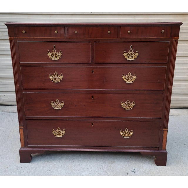 Featured is an absolutely phenomenal Antique English Inlaid Mahogany 8 Drawer Gentleman's Tall Chest. Solid brass...