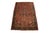 Hand-knotted area rug features a prominent, multi-layered geometric central medallion that anchors a vibrant rust-red...