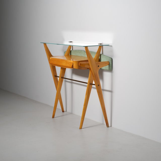 Italian console from the 1950s, attributed to Ico Parisi, showcasing refined cabinetmaking and a distinctly sculptural...