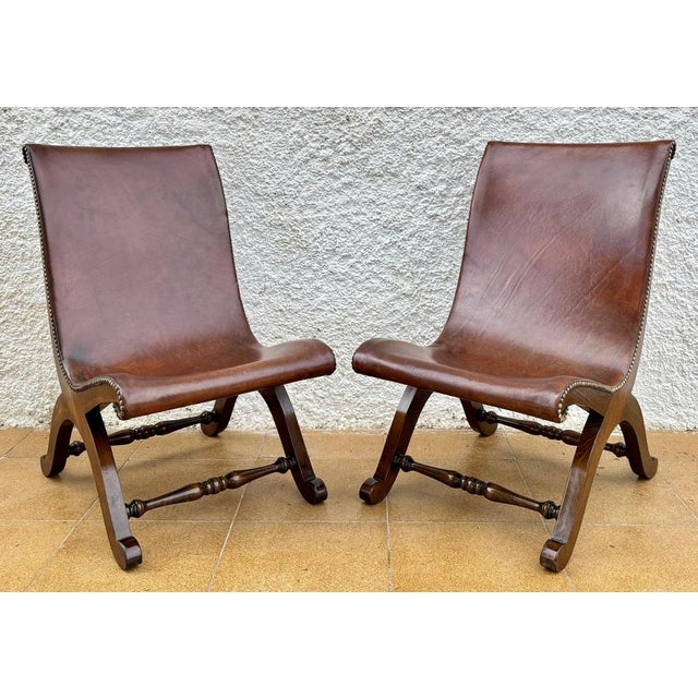 Pair of Spanish side chairs designed by Pierre Lottier for Valenti, 1950s. Oak wood structure with curved and harmonious...
