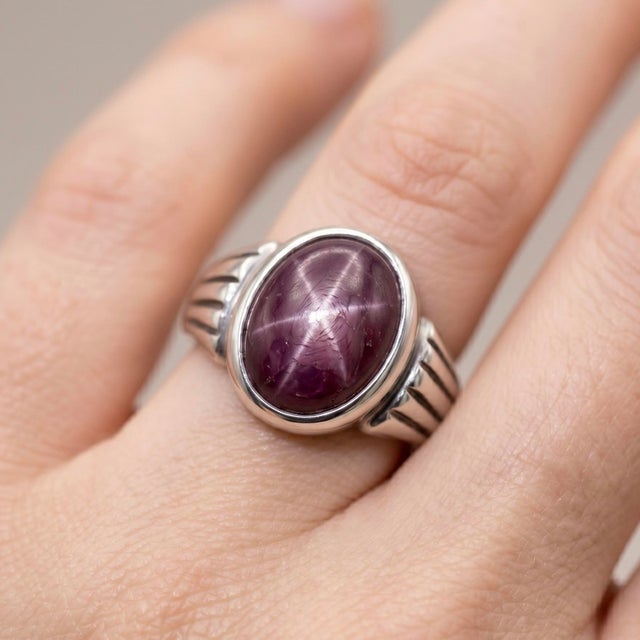 Crafted with a bold yet timeless aesthetic, this elegant ring features a captivating Star Ruby gemstone, renowned for its...