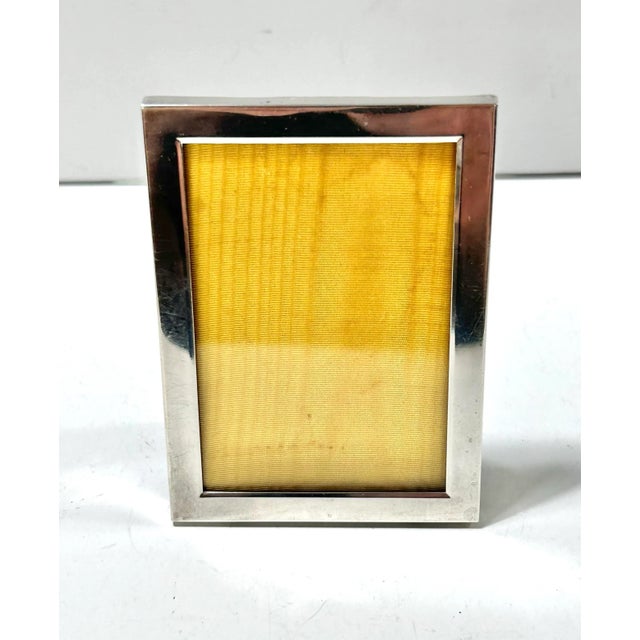 An elegant antique sterling silver picture frame manufactured by Webster Silver Company in the early 20th century. The...