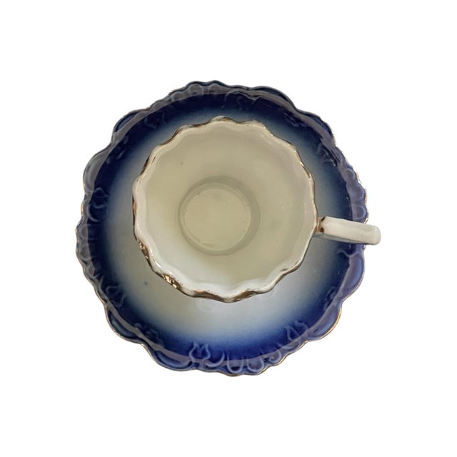Beautiful German porcelain demitasse cup and saucer with a cobalt blue gradient in flow blue style with gold gilded edges...