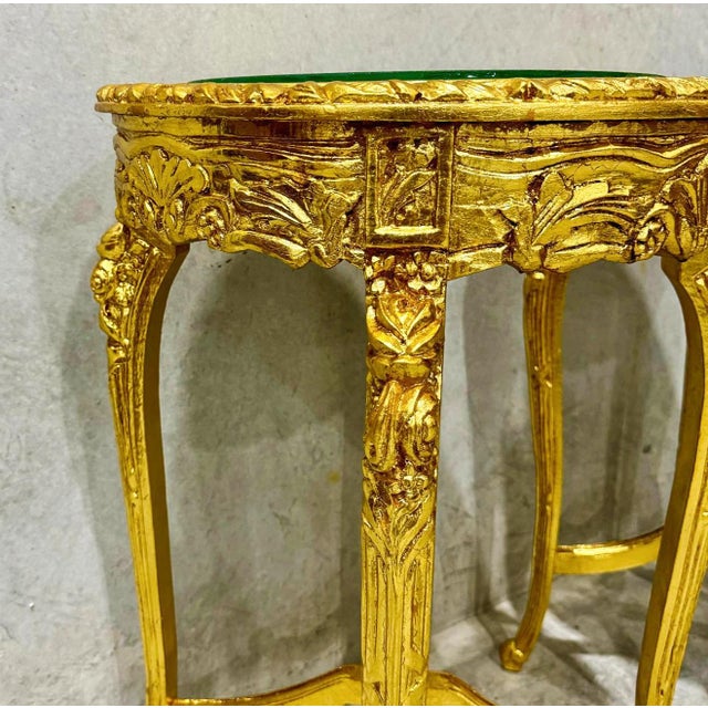 Elevate your living space with this exquisite French-style side table. Fully adorned with luxurious gold leaf, this piece...