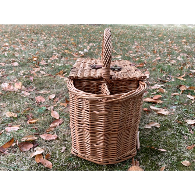 Beautiful Wicker Picnic Basket with Two Bottle Holder sections. Brass buckle Fastening Closure with a little rust. Two...