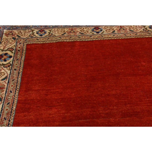 Originating from Persia in 1940, this vintage Mahal Persian Runner hosts an uncommon open field design from a...