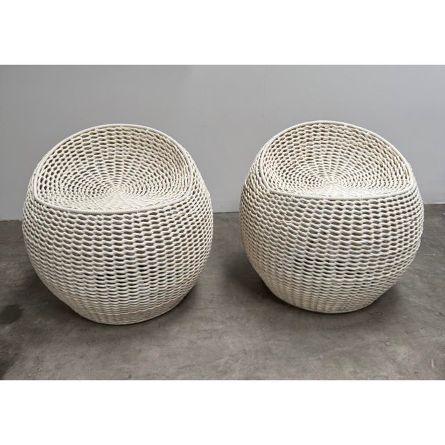 Pair of outdoor swivel chairs by Palecek. Synthetic woven fibers on powder coated aluminum frames. Materials are graded...