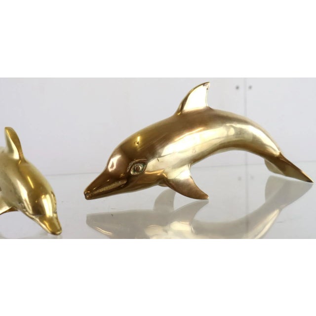 Set of 2 vintage brass dolphins in generous format. Beautiful on a dresser, or in a beautiful cupboard. Set of 2. Height:...