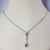 14K White Gold Sapphire and Diamond Pendant Necklace JAGi Certified- This stunning pendant necklace features two pearl cut...