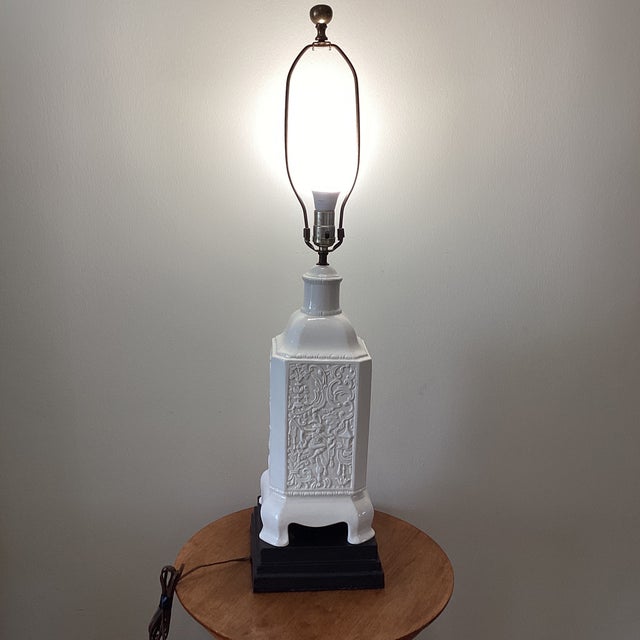 This Chinoiserie Pagoda Style Lamp features a white textured porcelain body mounted on a wooden base, exuding an Oriental...