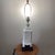 This Chinoiserie Pagoda Style Lamp features a white textured porcelain body mounted on a wooden base, exuding an Oriental...