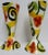 Bold shades of red, orange, yellow and green on white compliment this pair of whimsical goblets by ceramic artist Marilee...
