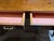 Handsome vintage campaign-style writing desk featuring a richly grained wood top and case, classic inset brass campaign...