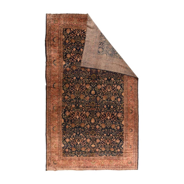 This particularly creative West Persian large carpet shows a navy ground evenly covered by a palmette, spiky rosette, bent...