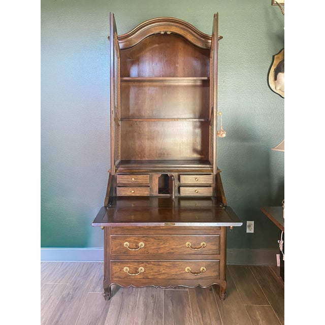 Beautiful vintage Baker secretary desk in a classic French Provincial style, featuring elegant wire mesh cabinet doors and...