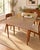 Classic vintage Mid-Century Modern dining table featuring a durable Formica/laminate top paired with a warm walnut-toned...