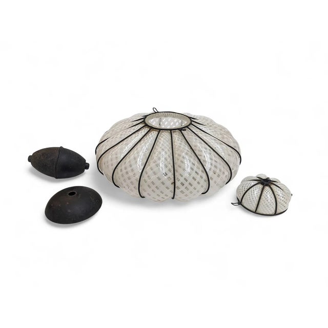 This beautiful Murano style blown glass pendant light features a white lattice design on a translucent background. It is...
