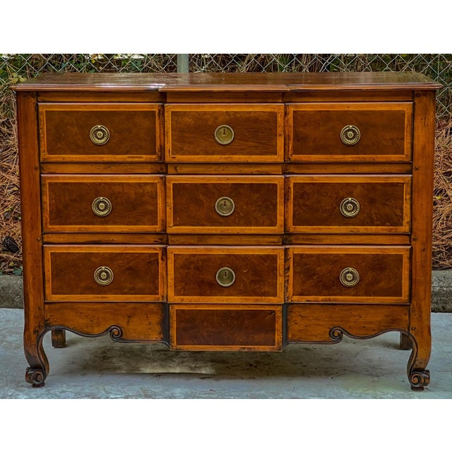 This is a lovely piece! This is a French Louis XV style carved fruitwood commode. It has inlaid block front styling along...