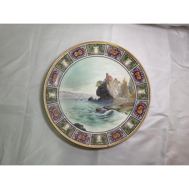Antique Nippon Wall Plate Beautiful hand painted porcelain plate is decorated with a seaside scene in the center. The rim...