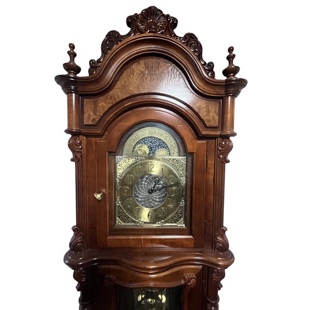 Traditional Victorian Revival grandfather clock crafted in cherry wood with striking burled cherry accents throughout the...