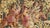This antique French tapestry, woven in wool and silk, depicts a lively hunting scene set within a richly detailed forest...