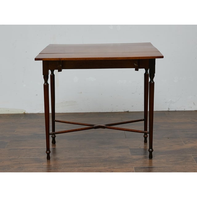 This elegant 19th-century English mahogany drop-leaf table offers both versatility and classic appeal. Crafted from rich...