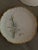 Hand painted set of bread and butter plates in green and white flowers. Gold rimmed. No cracks or chips