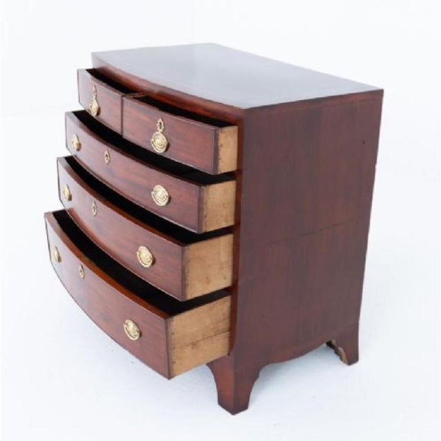 A charming Regency mahogany bow-front chest of drawers of diminutive proportions, raised on elegant splay feet with a...