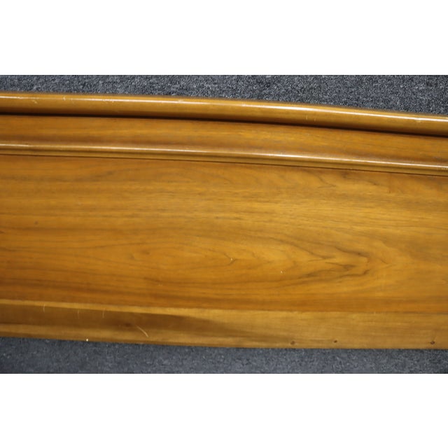Mid-Century Modern headboard attributed to Broyhill, dating to the 1960s. Constructed with a warm walnut-toned wood finish...