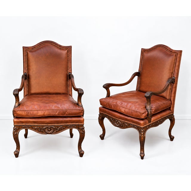 This is a pair of Hickory Chair / Pearson French Louis XIV style carved walnut and leather bergere chairs. Pearson Co. is...