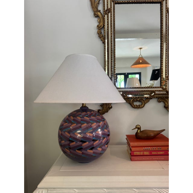 This pair of two round lamps features a mix of purple, orange, blue, and gold tones. The colorful pattern adds a fun touch...