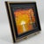 Original lighthouse painting on canvas board, depicting a striking coastal scene illuminated by a brilliant golden sunset....