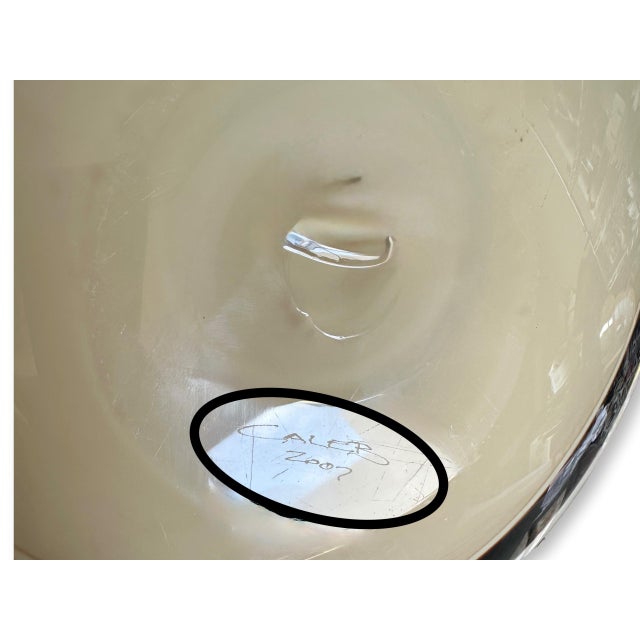 A luminous sculptural bowl by American glass artist Caleb Siemon, signed and dated 2007. This piece is all about movement...