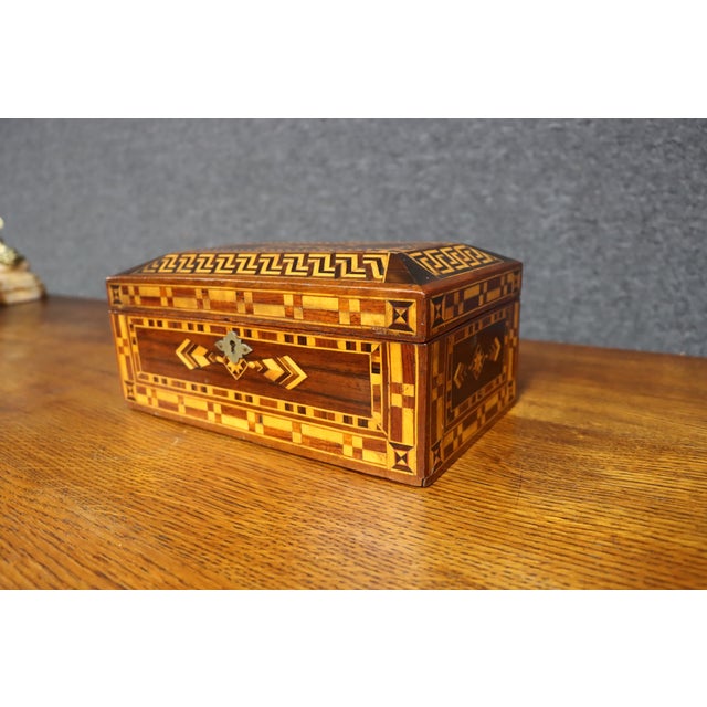 Fine Victorian marquetry jewelry box crafted from mahogany, rosewood and satinwood, elaborately decorated with geometric...