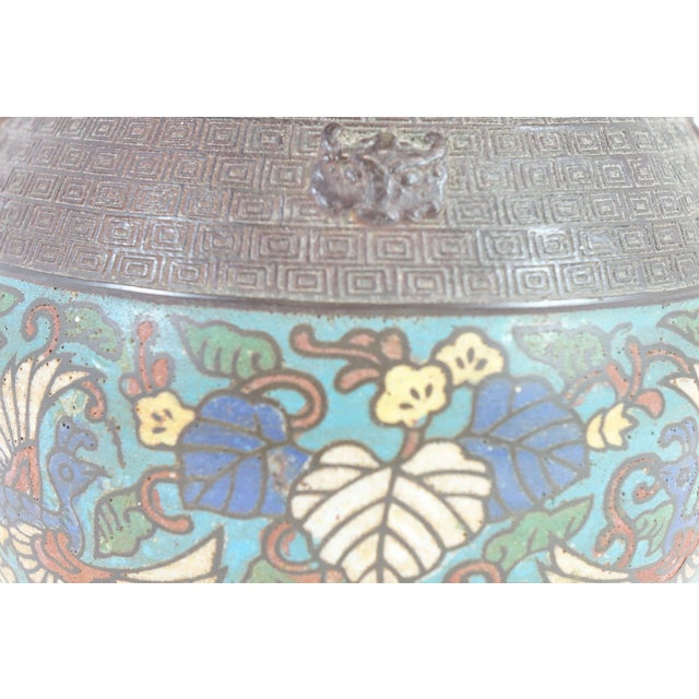 Antique Chinese Bronze Cloisonné Vase with Two Handles – 8.5ʺ × 8.5ʺ × 11.5ʺ This exquisite antique Chinese bronze...