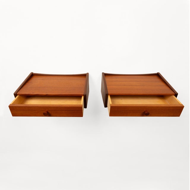This beautiful pair of vintage Danish mid-century teak nightstands showcases the timeless appeal of Scandinavian modern...