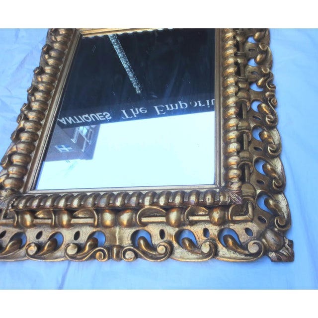 Antique Italian gilt wooden mirror. Mid-19th century carved frame with a modern clear mirror. Heavily carved and intricate...