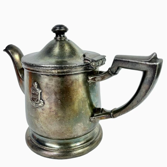 Add a touch of Chicago history to your decor with this classic and charming silver soldered Stevens Hotel teapot with the...