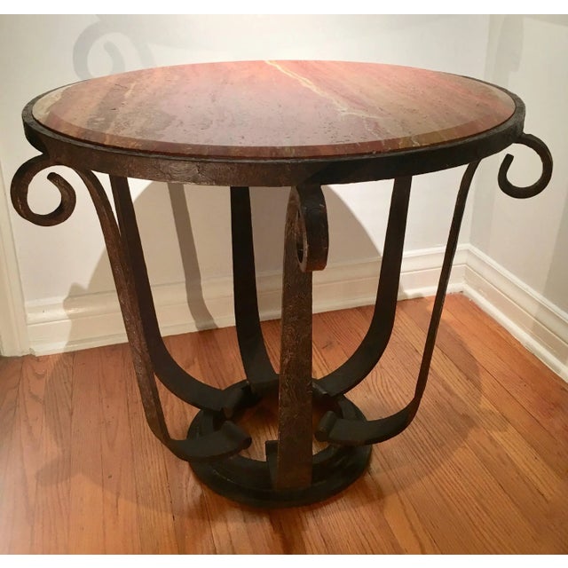 A handsome example after Raymond Subes - variegated and dynamic beveled marble top with well designed wrought iron base -...