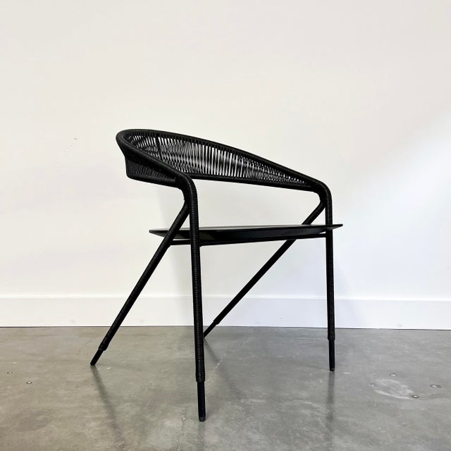 Living Divani Georges Chair with a black ash seat, black steel frame wrapped in black hide cord.