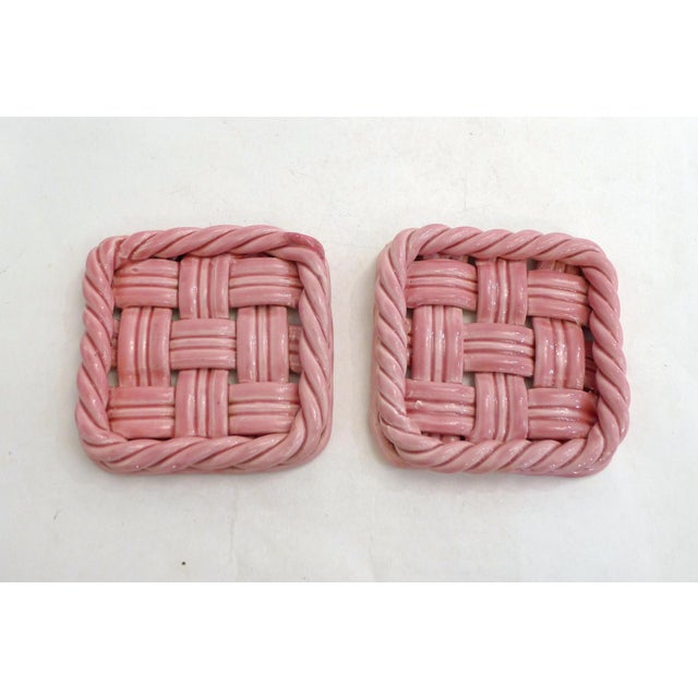 Pair of mid-century bottle coasters (or two small trivets), square shape with rounded corners, twisted rim, and openwork...