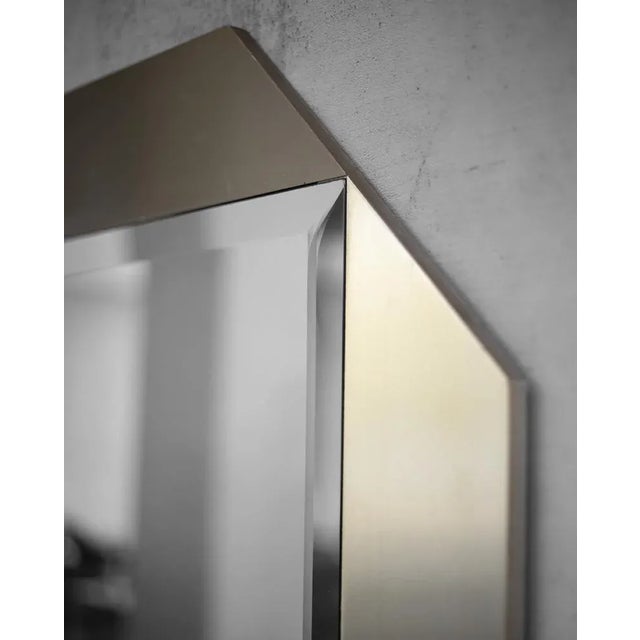 The octagon-shaped mirror comes from Italy. It has a frame made of brushed brass (which is less golden than traditional...