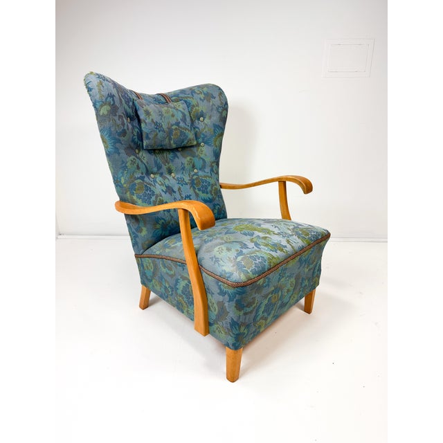 1950's high back Swedish lounge chair. Sculpted Birch wood frame. Vintage upholstery.